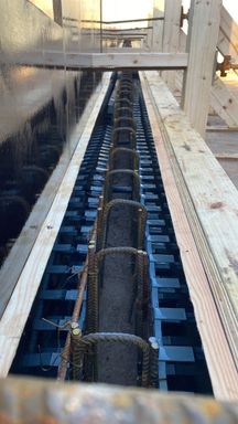 Reinforcement links and a void former inside a timber shuttered ground beam