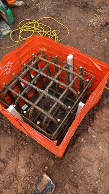 Pile cap reinforcement cage set inside a proprietary shutter in excavated ground